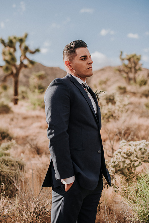 groom in a blue suit and a long floral tie