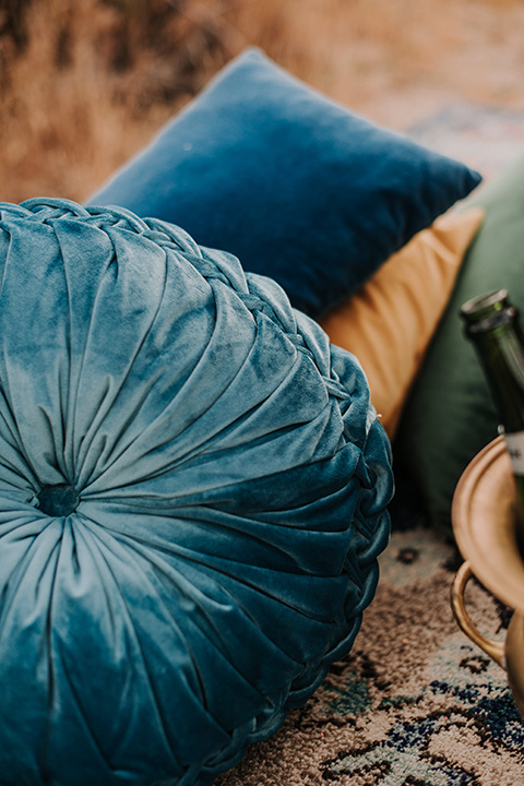 blue pillows on the ground in a boho style