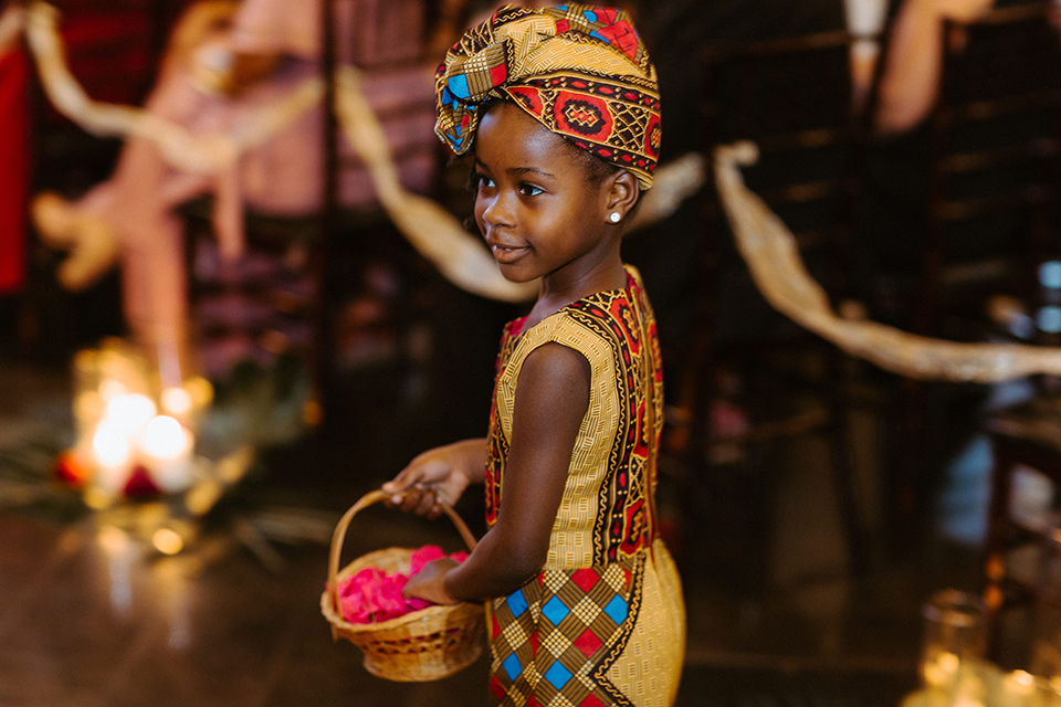 flower girl in a yellow African dress and headpiece