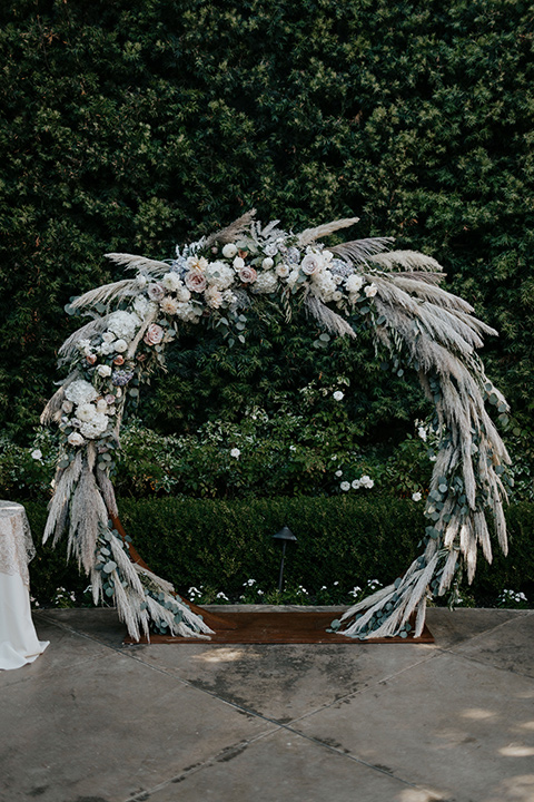 arch with muted tones and light pink florals in a circular arch
