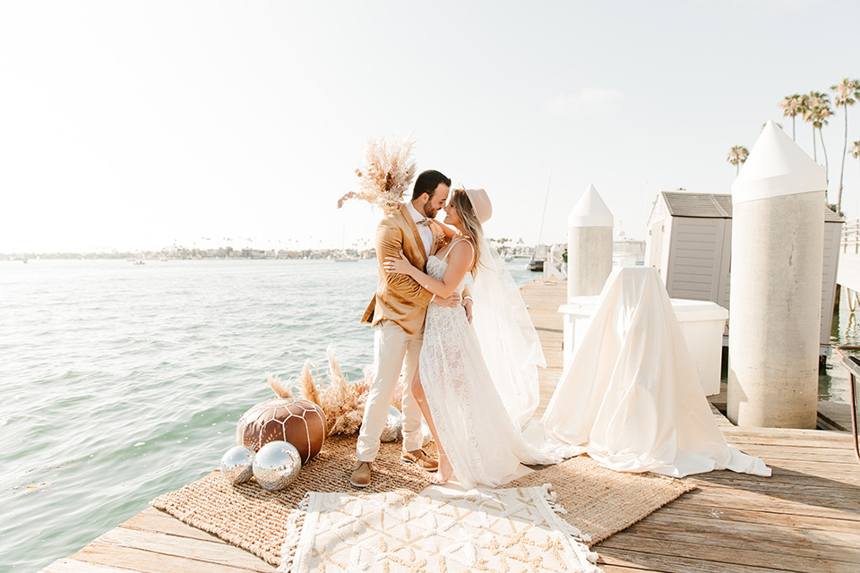  1970s golden hour boat elopement – couple kissing at ceremony 