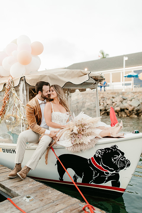  1970s golden hour boat elopement – walking on boardwalk at boat 