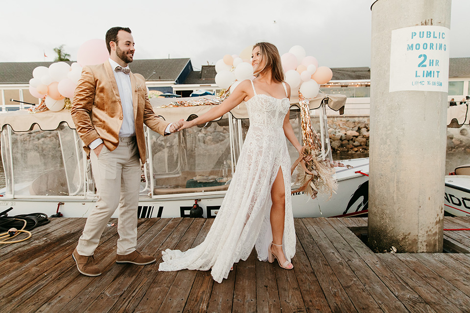  1970s golden hour boat elopement – walking to the boat 