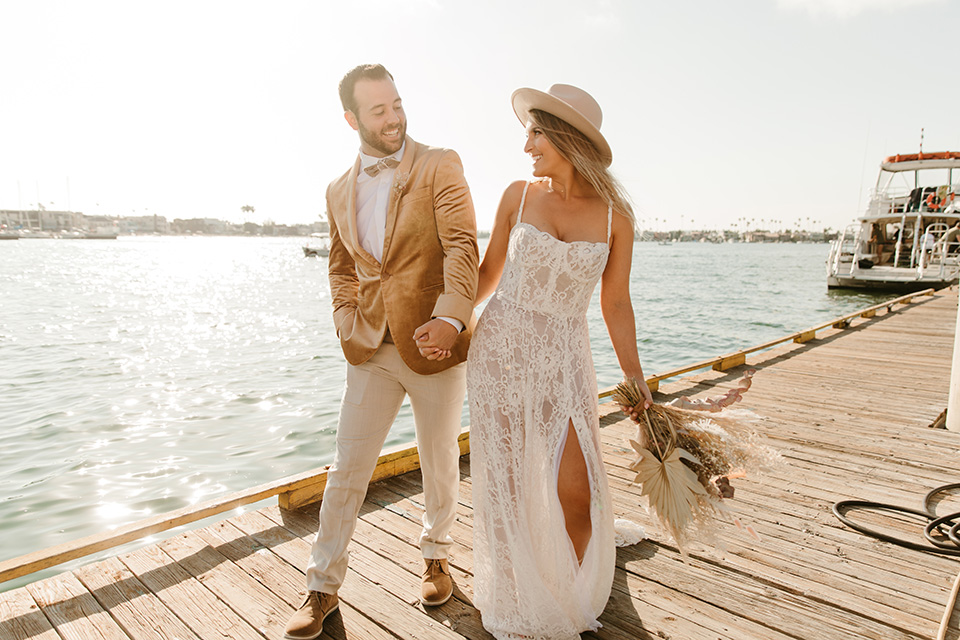  1970s golden hour boat elopement – walking on the board walk 