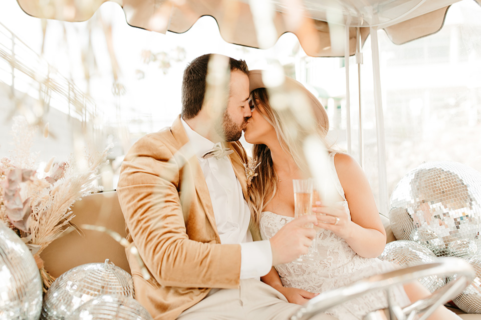  1970s golden hour boat elopement – kissing on the boat 