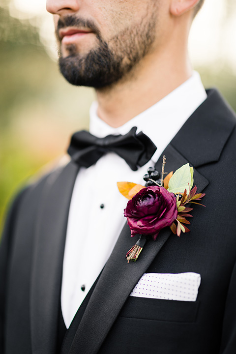  old world wedding at Allegretto Vineyard Resort – bride in a long gown with a cutout back design and the groom in black tuxedo with a black diamond bow tie at ceremony 