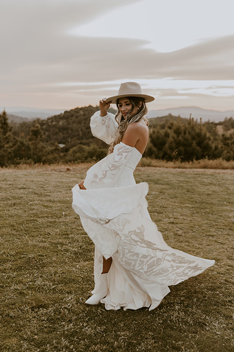 bride in a rue de sine gown and boho wide brimmed hat  