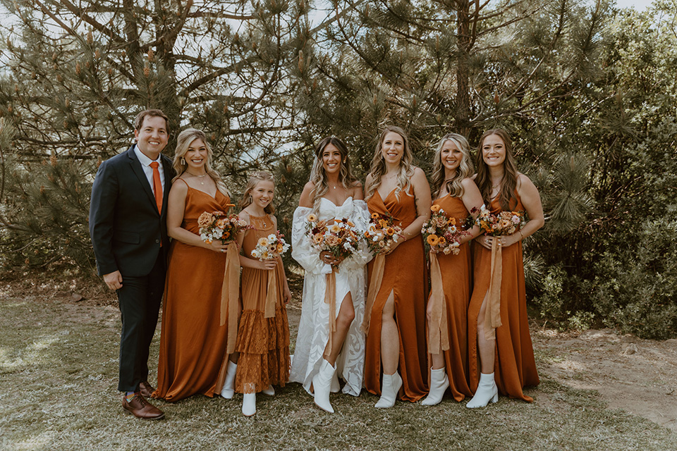  the bridesmaids in deep orange gowns 