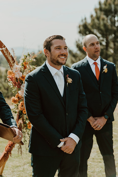  groom waiting for the bride at the end of the aisle  