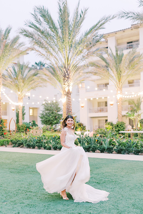  black tie wedding with a sting light reception and the bride in a modern ballgown and the groom in a black tuxedo 