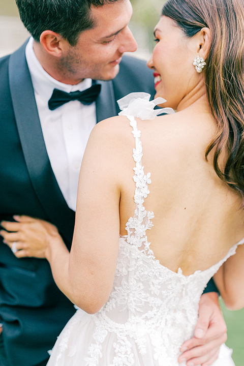  black tie wedding with a sting light reception and the bride in a modern ballgown and the groom in a black tuxedo 