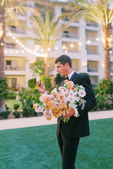  black tie wedding with a sting light reception and the bride in a modern ballgown and the groom in a black tuxedo 