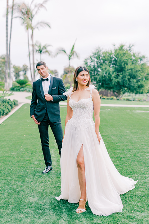  black tie wedding with a sting light reception and the bride in a modern ballgown and the groom in a black tuxedo 