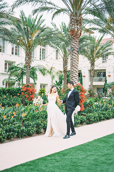  black tie wedding with a sting light reception and the bride in a modern ballgown and the groom in a black tuxedo 