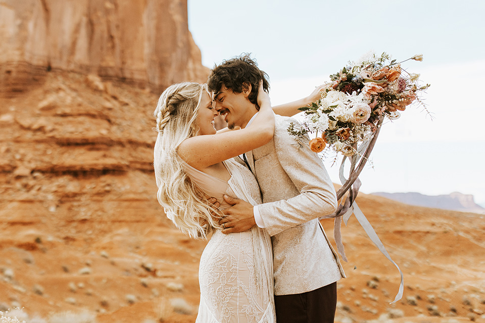  bohemian elopement in antelope canyon – couple embrace 