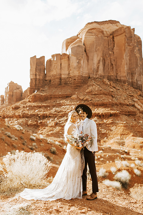  bohemian elopement in antelope canyon – couple close with flowers 