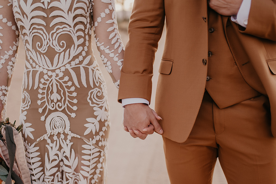  bohemian bride in a rue de sine gown and the groom in a caramel suit 