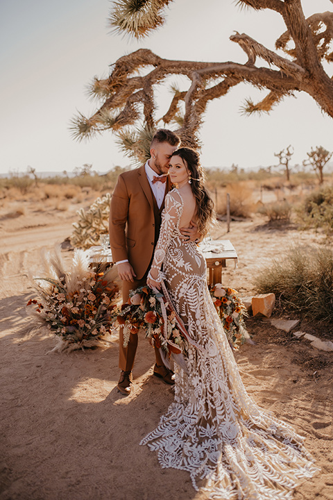  bohemian bride in a rue de sine gown and the groom in a caramel suit 