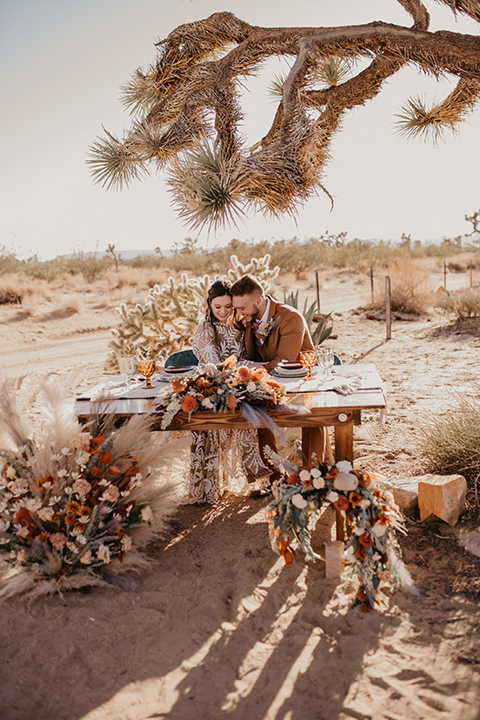  bohemian bride in a rue de sine gown and the groom in a caramel suit