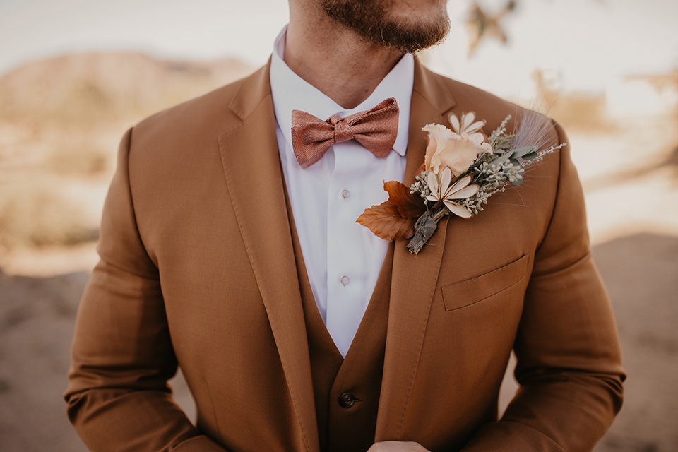  bohemian bride in a rue de sine gown and the groom in a caramel suit 