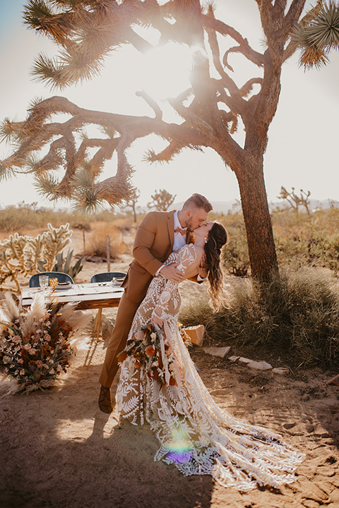  bohemian bride in a rue de sine gown and the groom in a caramel suit 