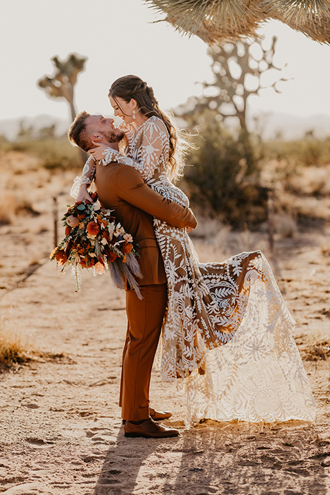  bohemian bride in a rue de sine gown and the groom in a caramel suit 