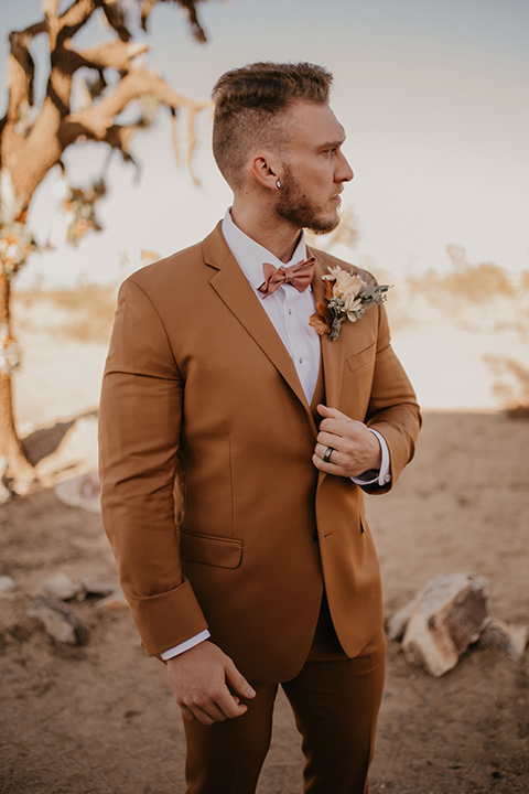  bohemian bride in a rue de sine gown and the groom in a caramel suit 