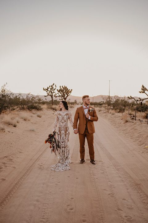  bohemian bride in a rue de sine gown and the groom in a caramel suit