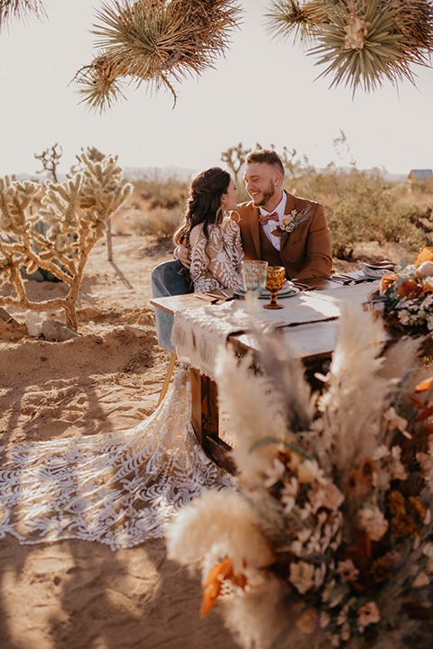  bohemian bride in a rue de sine gown and the groom in a caramel suit 