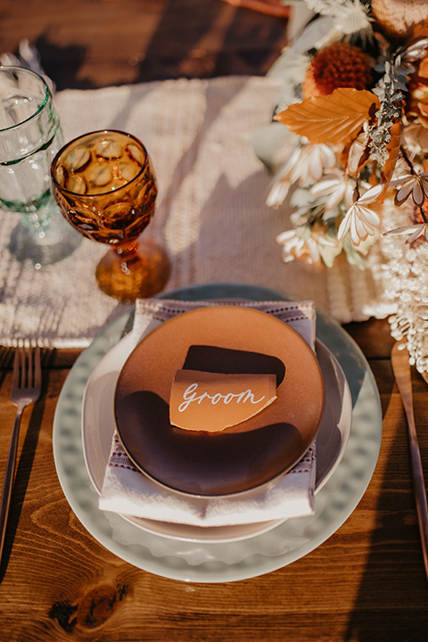  bohemian bride in a rue de sine gown and the groom in a caramel suit