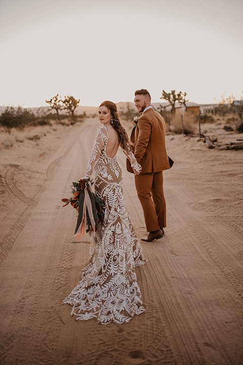  bohemian bride in a rue de sine gown and the groom in a caramel suit 