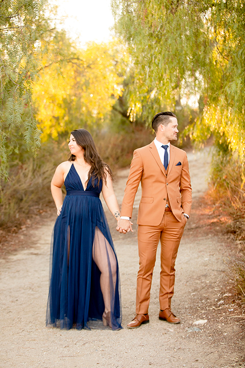  engagement photos with the groom in a caramel suit and the bride in a white suit 