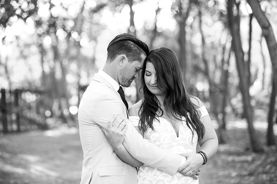  engagement photos with the groom in a tan suit and the bride in a white suit 