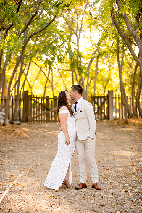  engagement photos with the groom in a tan suit and the bride in a white suit 