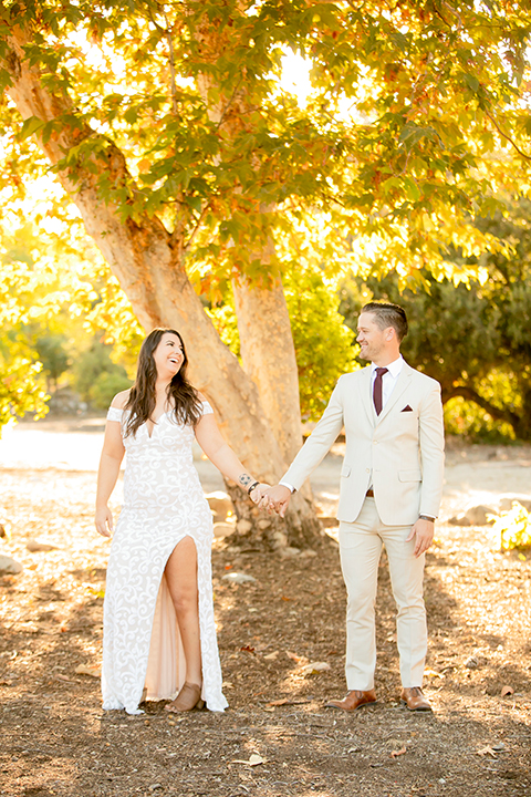  engagement photos with the groom in a tan suit and the bride in a white suit 