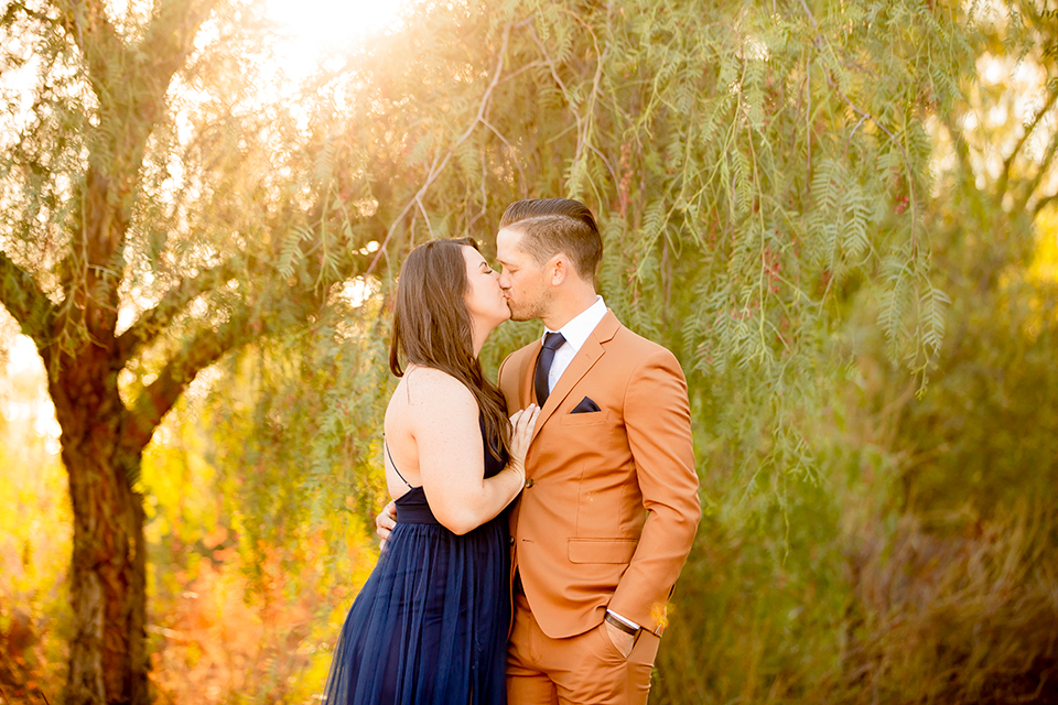  engagement photos with the groom in a tan suit and the bride in a white suit 