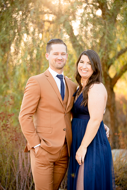  engagement photos with the groom in a caramel suit and the bride in a white suit 