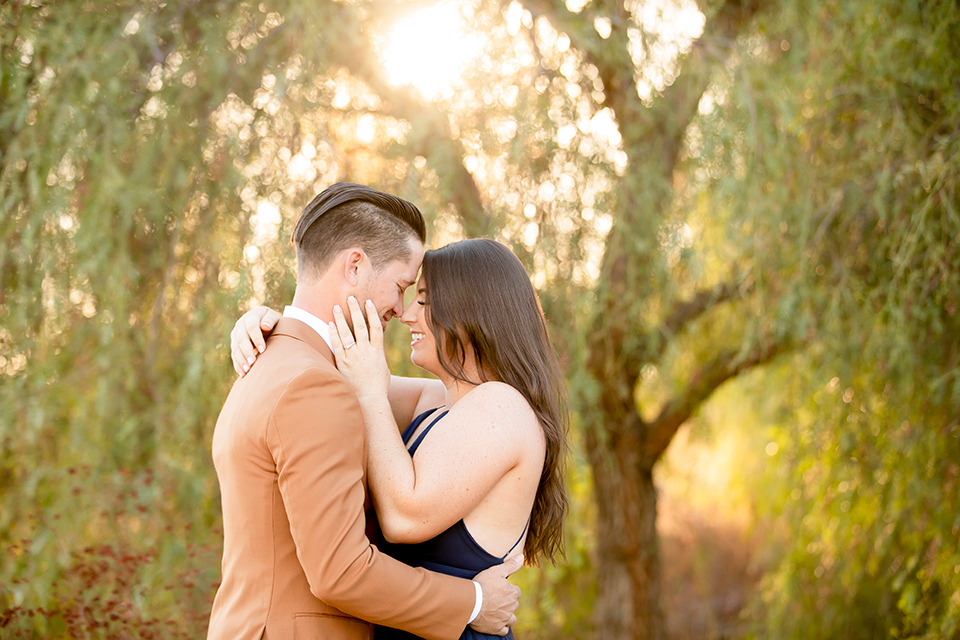  engagement photos with the groom in a tan suit and the bride in a white suit 