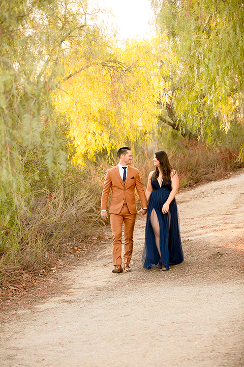  engagement photos with the groom in a tan suit and the bride in a white suit 