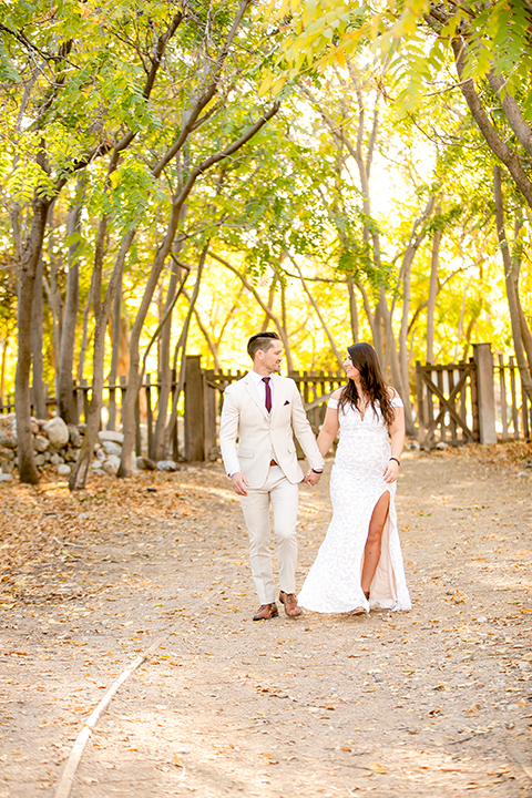  engagement photos with the groom in a tan suit and the bride in a white suit 