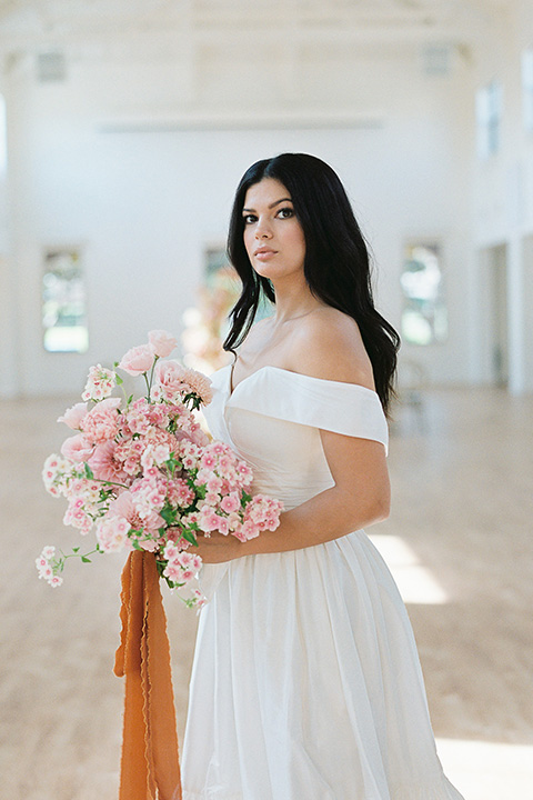  building 177 romantic coral wedding – gown in a long dress with an off the shoulder detail 