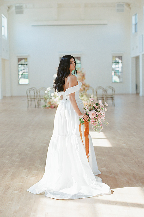  building 177 romantic coral wedding – gown in a long dress with an off the shoulder detail 