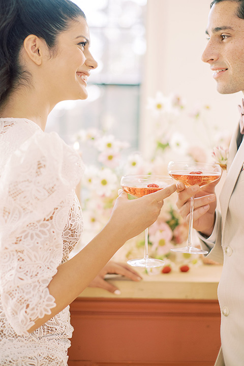  building 177 romantic coral wedding – couple with drinks