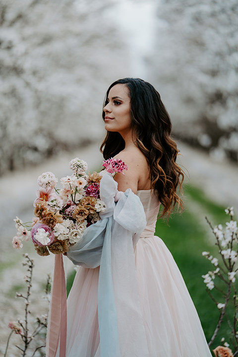   bride in a pastel pink and blue gown