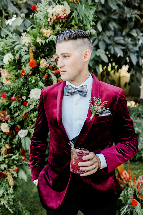  Christmas styled shoot with the groom in a burgundy velvet tuxedo and black pants 