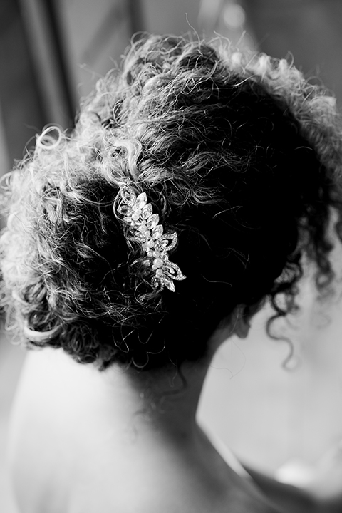  bride in a two-piece gown with her hair in a chic up-do