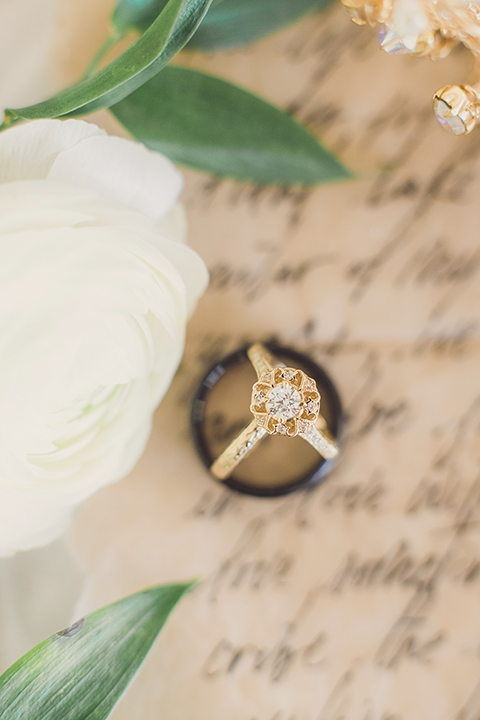  bride in a black lace gown and the groom in a green velvet tuxedo with a black bow tie and shoes 