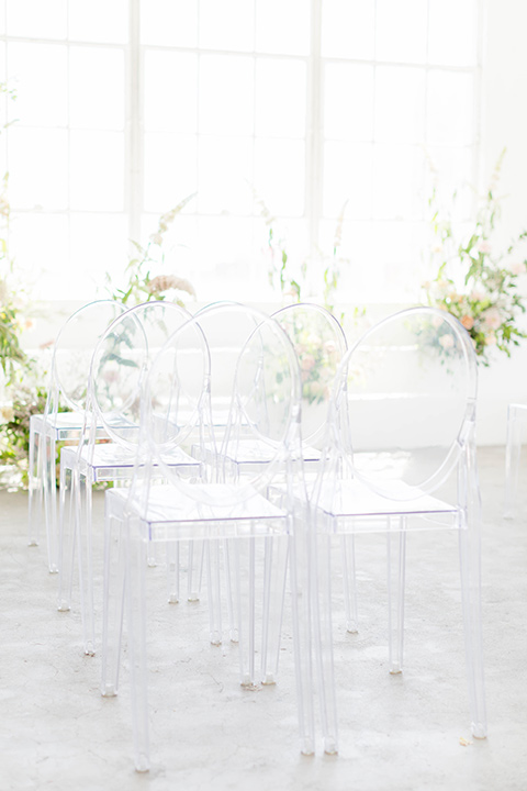  a modern black tie style wedding with the bride in a formfitting gown with a tulle off the shoulder 2 piece wedding gown and the groom in a black tuxedo