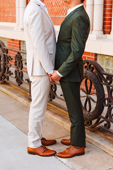  engagement shoot in long beach CA with one groom in a tan suit and the other groom in a green suit 