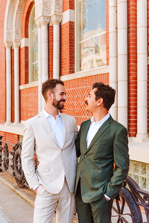  engagement shoot in long beach CA with one groom in a tan suit and the other groom in a green suit